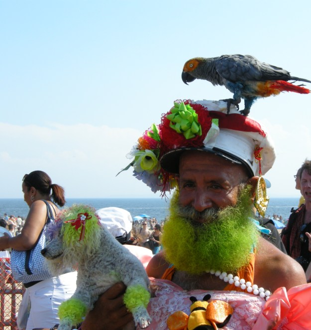 An on old merman on the boardwalk with his poodle and his parrot.  (Photo by author.)